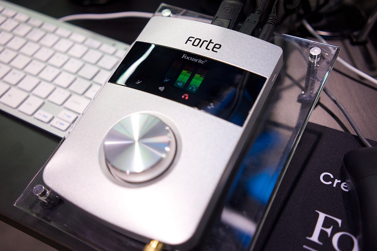Desktop audio interface beside a computer keyboard
