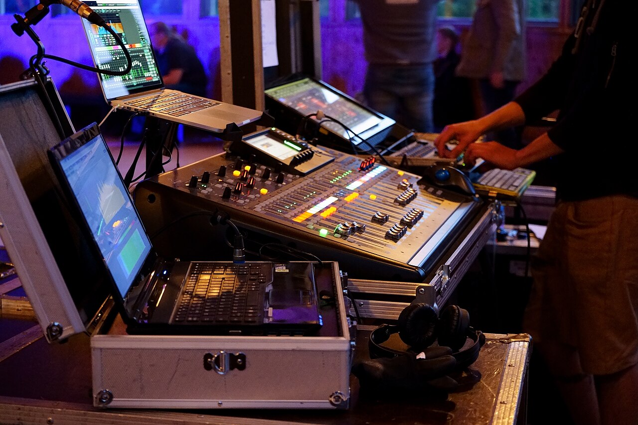 Engineer operating a concert mixing console