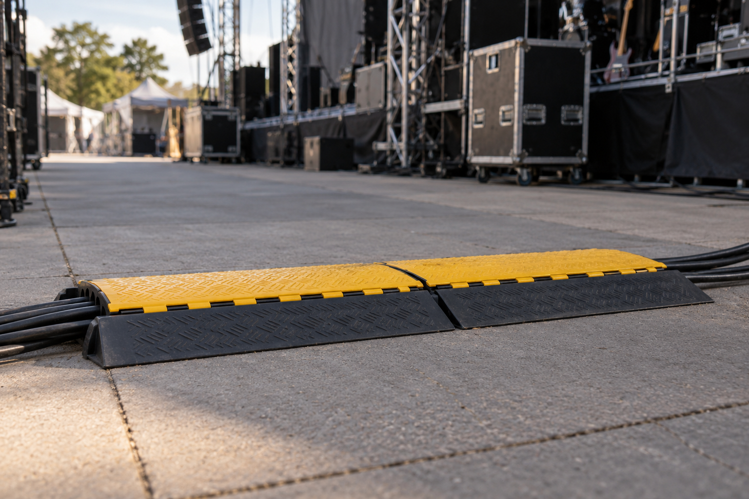 AI-generated illustration of yellow and black cable protectors beside an outdoor stage