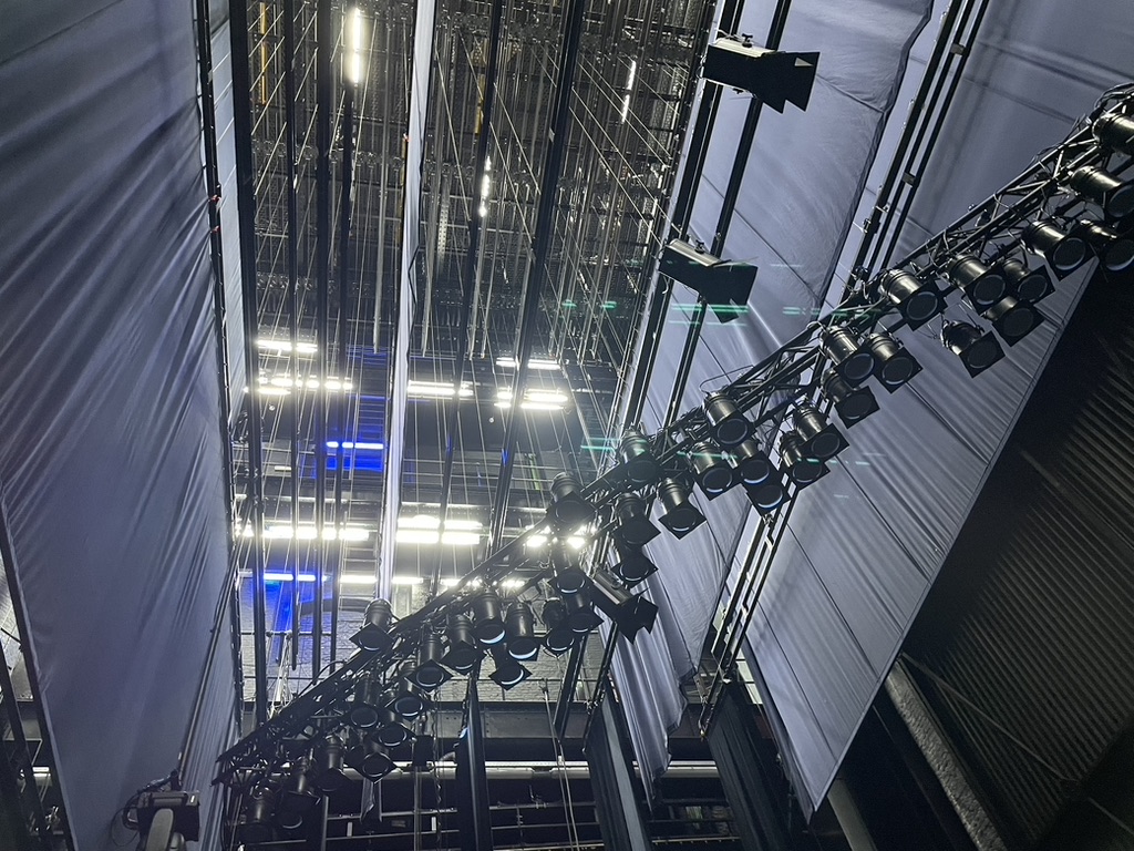 Stage lighting fixtures suspended above a theatre