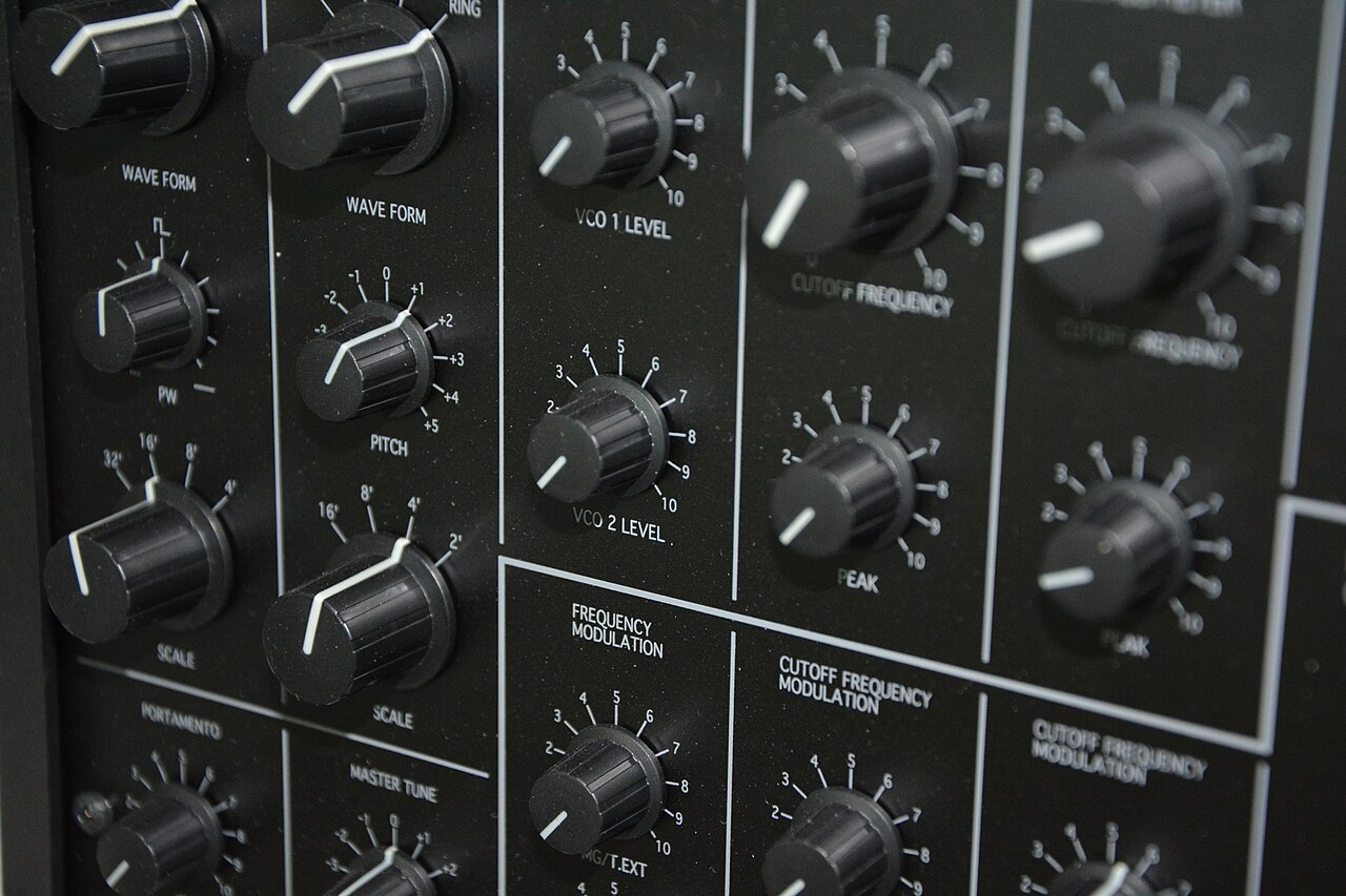 Synthesizer panel with rows of control knobs